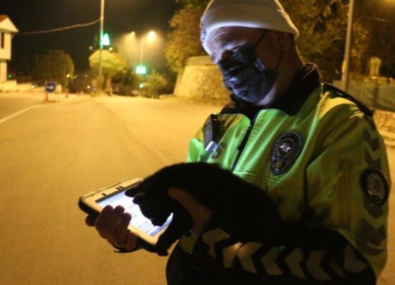 Trafik polisi araç altında kalmaktan kurtardığı kediyle uygulamaya devam etti